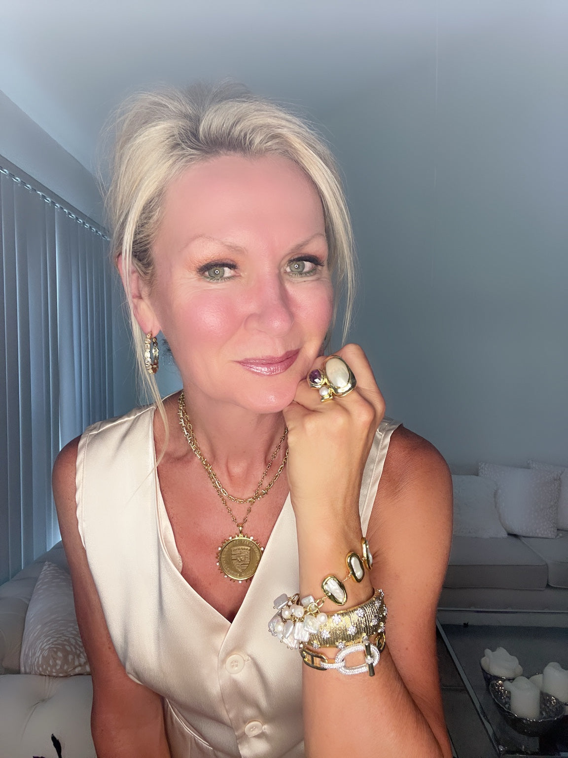 Christine wearing the buckle bracelet in a layered gold-tone look