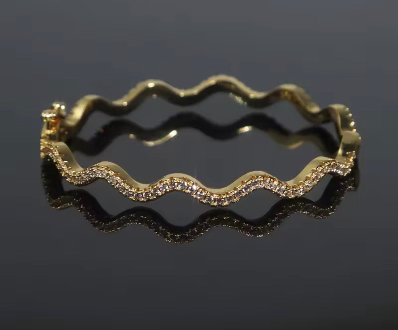 Matching wavy pavé bangle bracelet in gold and silver finishes