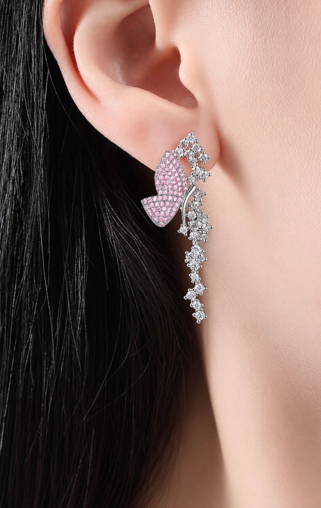 Pink pavé butterfly dangle earring worn