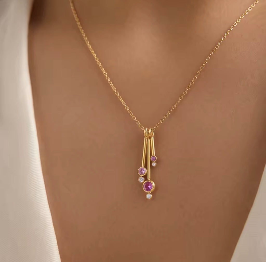 Pink dancing teardrop necklace styled on model