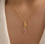 Pink dancing teardrop necklace styled on model