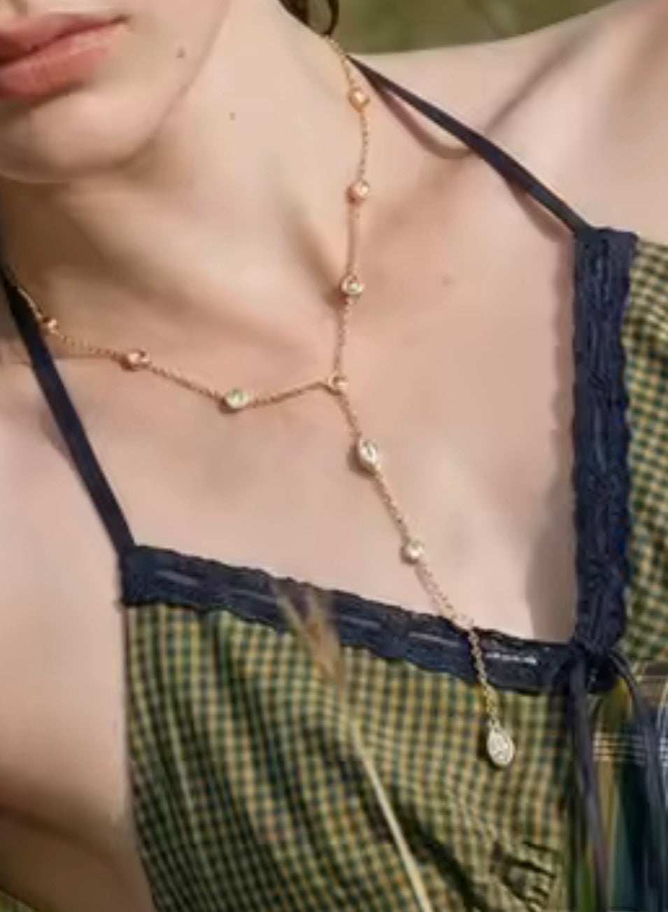 Gold diamond bezel lariat necklace styled for layering