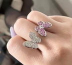 Double butterfly ring shown worn on a hand