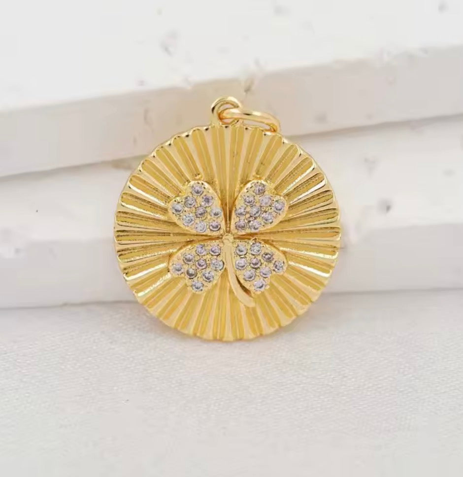 Gold clover and round four-leaf clover pendant shown together with measurements