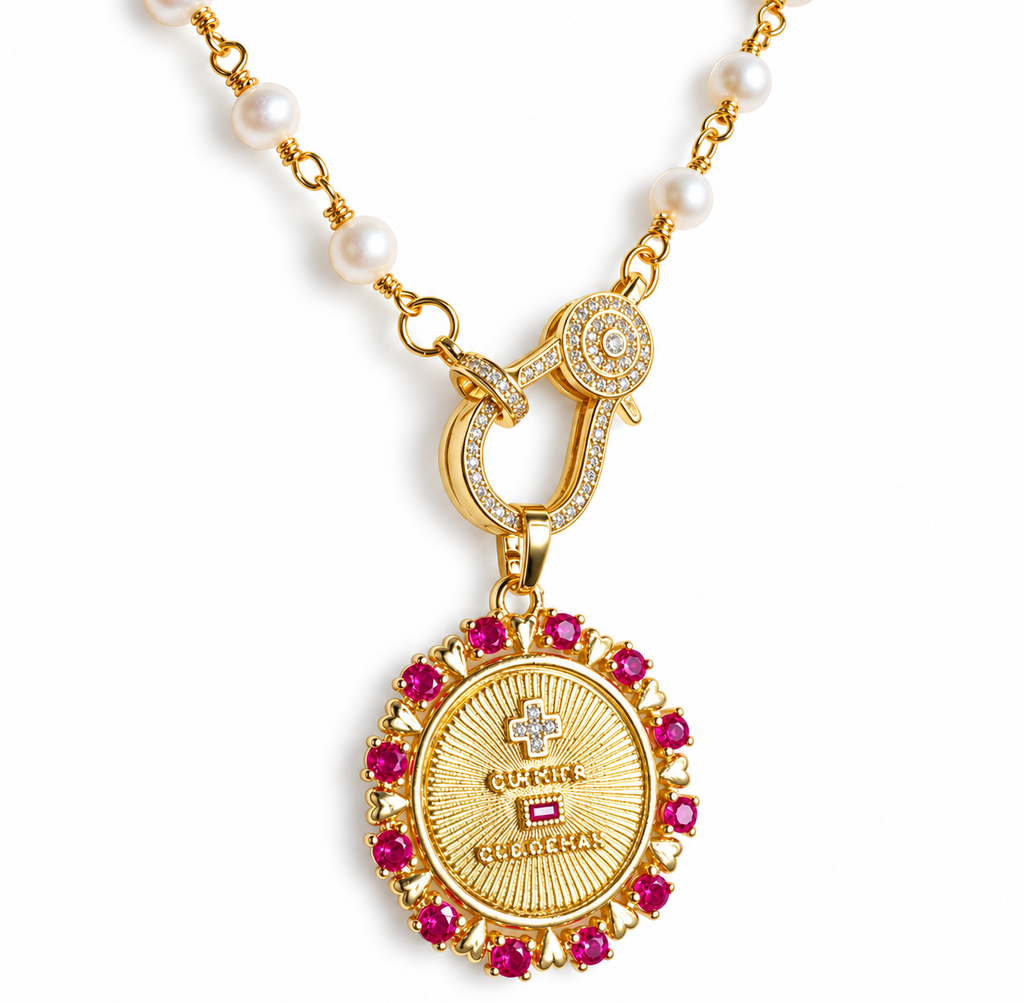 Close-up detail of the French Ruby & Pearl necklace pendant on white background