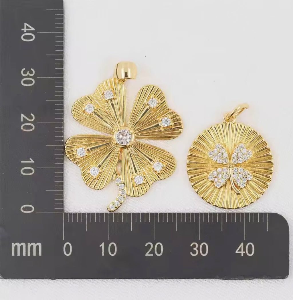 Round gold pendant with four-leaf clover detail