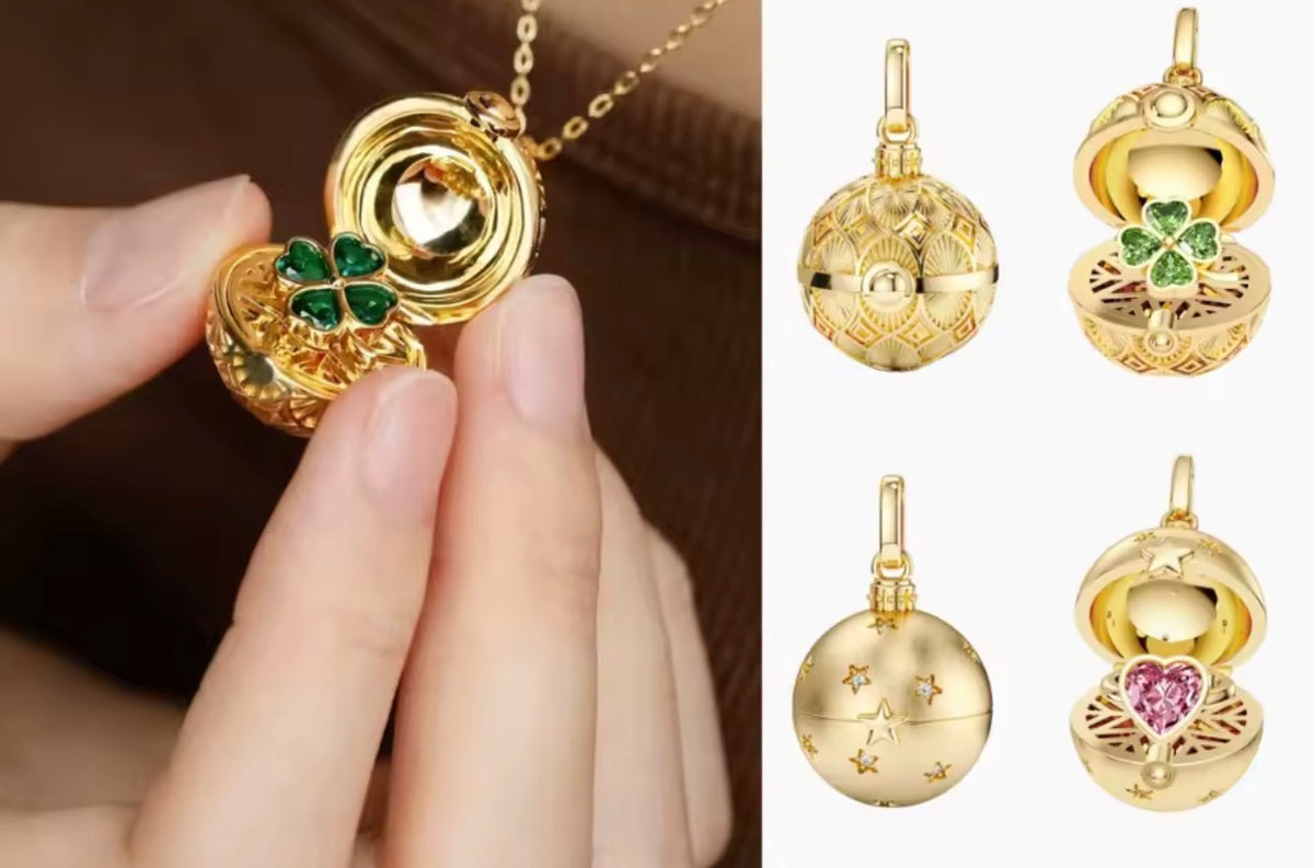 Gold globe charm necklace showing the green clover and pink heart styles