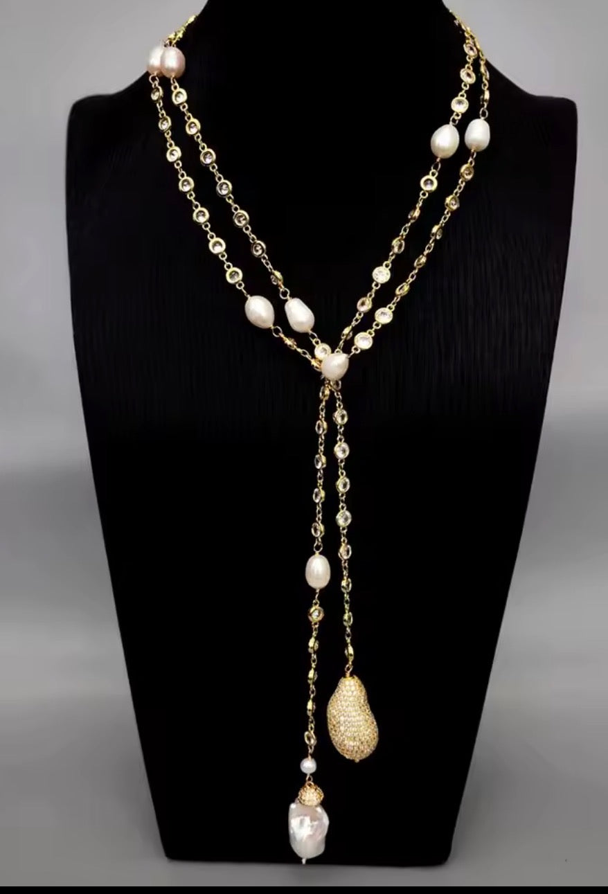 Gold and pearl wrap necklace styled on a necklace display