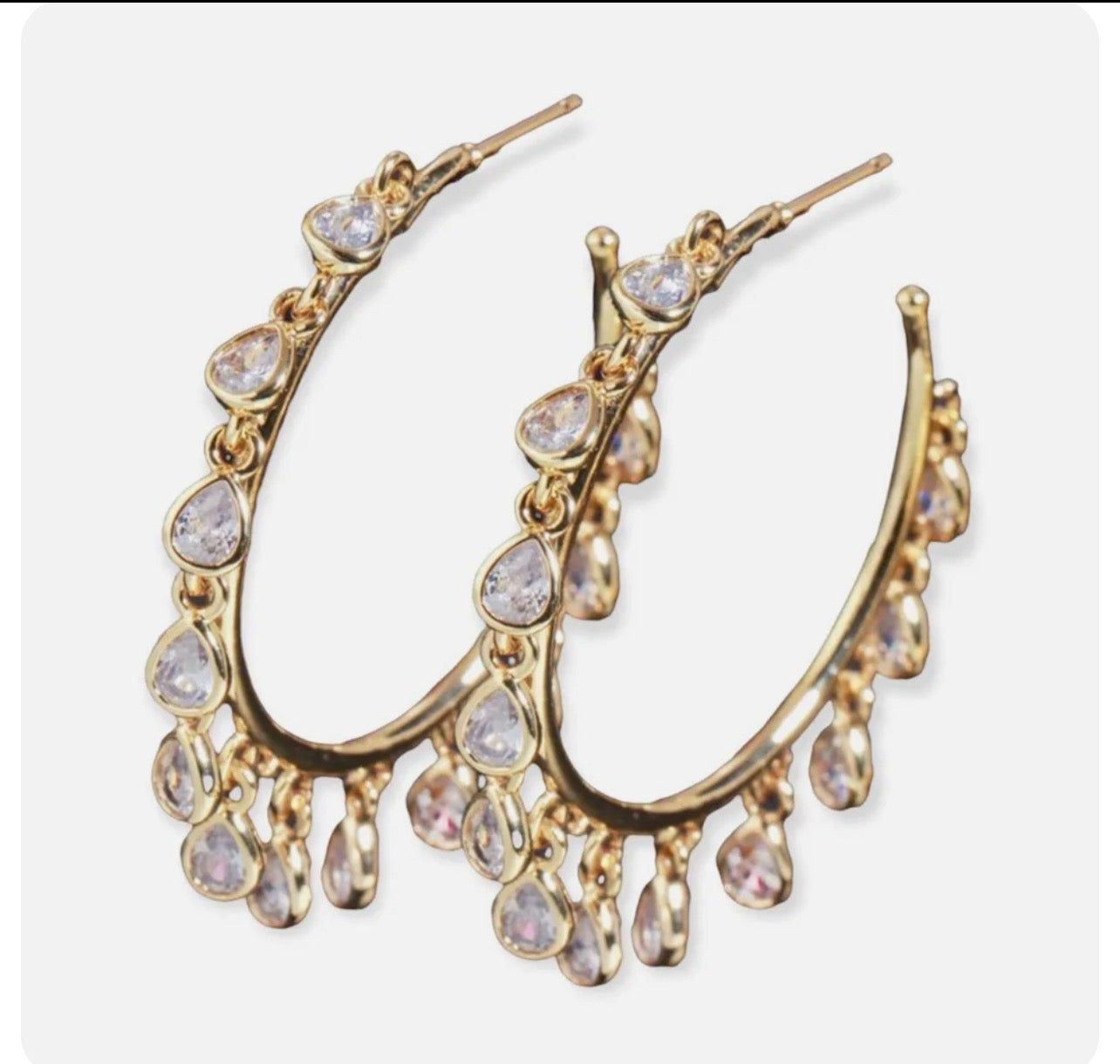 Gold teardrop stone hoop earrings with clear stones