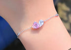 Pink and white heart bracelet shown on the wrist
