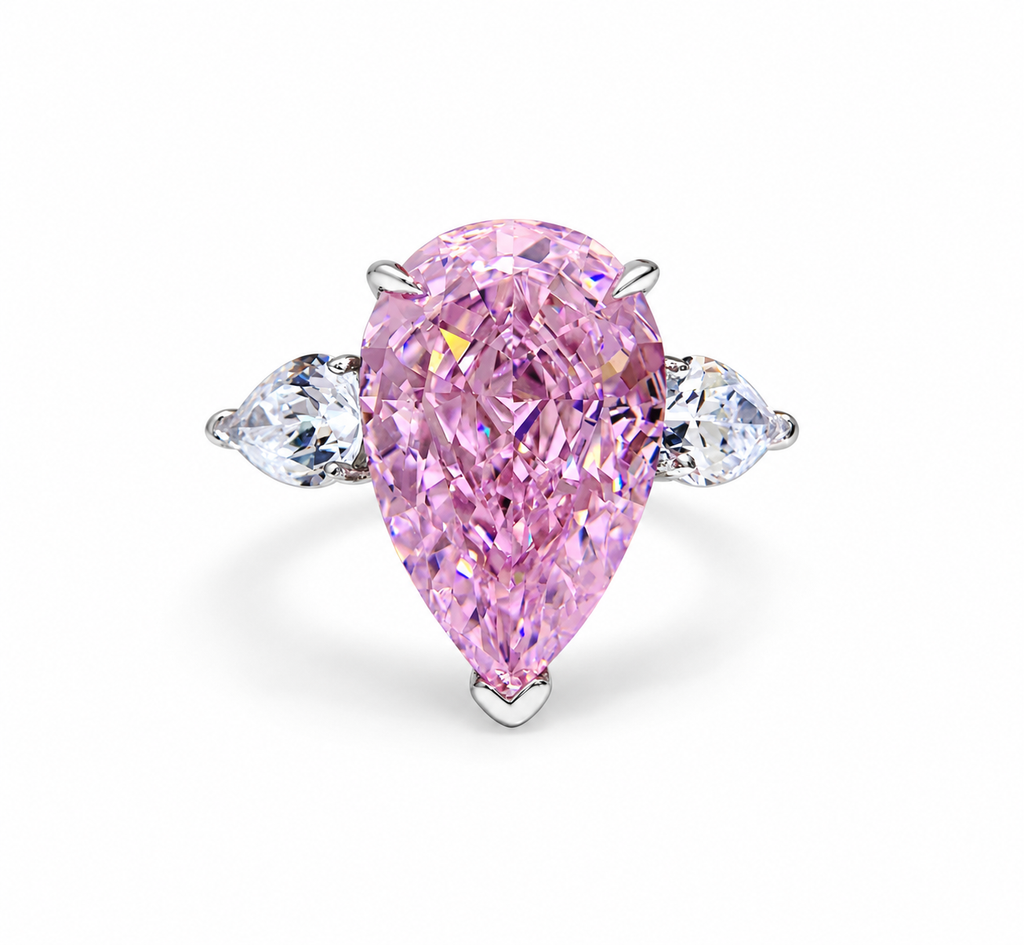 Large pink pear-cut simulated diamond statement ring on a white background
