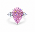 Large pink pear-cut simulated diamond statement ring on a white background
