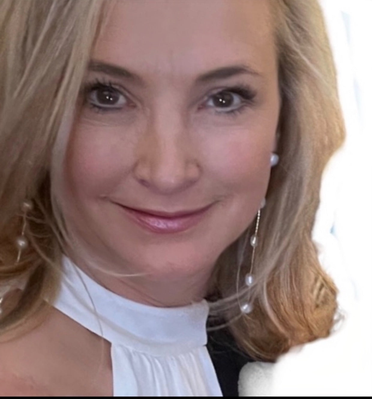 Christine wearing long freshwater pearl dangle earrings