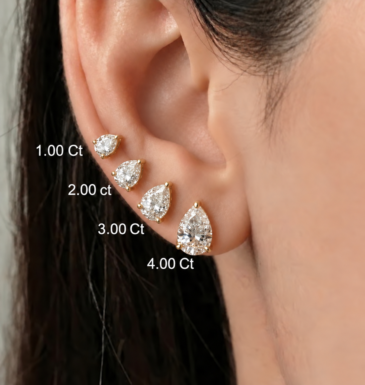 Pear-shaped lab diamond stud earrings shown in 1, 2, 3, and 4 carat sizes