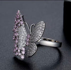 Pink and white butterfly ring shown worn