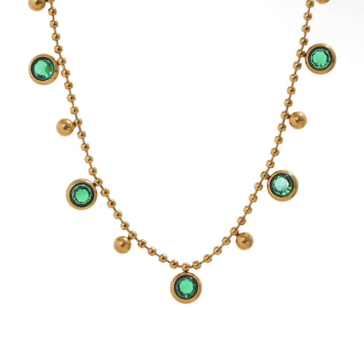 Green multi-stone gold necklace shown as a layering suggestion; sold separately